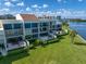 Waterfront condo building with private balconies and lush landscaping at 50 Coe Rd # 125, Belleair, FL 33756