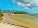 Calm beach with kayaks and clear water at 3047 Enisglen Dr, Palm Harbor, FL 34683