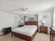 Main bedroom with wood platform bed and ceiling fan at 3047 Enisglen Dr, Palm Harbor, FL 34683
