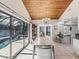Bright dining room with marble table and pool view at 3047 Enisglen Dr, Palm Harbor, FL 34683