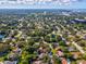 Wide aerial view showing home's location in a residential neighborhood at 3047 Enisglen Dr, Palm Harbor, FL 34683