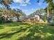 Large backyard with screened pool and plenty of space for outdoor activities at 3047 Enisglen Dr, Palm Harbor, FL 34683