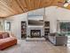 Living room with fireplace, wood ceiling and large TV at 3047 Enisglen Dr, Palm Harbor, FL 34683