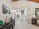 Bright entryway with staircase, tile floors, and decorative console table at 3047 Enisglen Dr, Palm Harbor, FL 34683