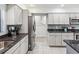 Kitchen with stainless steel appliances and granite countertops at 3047 Enisglen Dr, Palm Harbor, FL 34683