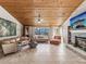 Living room with a fireplace and wood paneled ceiling at 3047 Enisglen Dr, Palm Harbor, FL 34683