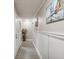 Bright hallway with wood-look flooring, decorative vase, and wall art at 3047 Enisglen Dr, Palm Harbor, FL 34683
