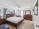 Main bedroom with a wood bed frame and large windows at 3047 Enisglen Dr, Palm Harbor, FL 34683