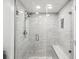 Modern shower with glass enclosure, stone tile, and dual shower heads at 3047 Enisglen Dr, Palm Harbor, FL 34683