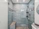 Modern shower with glass enclosure, built-in seat, and pebble floor at 3047 Enisglen Dr, Palm Harbor, FL 34683