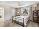 Bedroom with coral comforter, ceiling fan, and dresser at 3047 Enisglen Dr, Palm Harbor, FL 34683