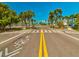 Beach parking lot with palm trees and bike path at 3047 Enisglen Dr, Palm Harbor, FL 34683