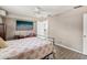 Bedroom with coral comforter, ceiling fan, and access to bathroom at 3047 Enisglen Dr, Palm Harbor, FL 34683