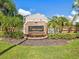 Eniswood community entrance with lush landscaping at 3047 Enisglen Dr, Palm Harbor, FL 34683