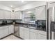 Modern kitchen with granite countertops and stainless steel appliances at 3047 Enisglen Dr, Palm Harbor, FL 34683