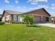 Brick ranch home with two-car garage and lush lawn at 3332 Mcmath Dr, Palm Harbor, FL 34684