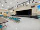 Spacious community room with a stage and seating at 3332 Mcmath Dr, Palm Harbor, FL 34684