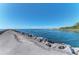 Calm waterway with a paved path along a rocky shoreline at 105 Dartmouth Rd, Venice, FL 34293