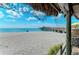 Beachfront property with pier and ocean views under a sunny sky at 105 Dartmouth Rd, Venice, FL 34293