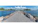 Serene ocean inlet with a stone jetty leading to the water at 105 Dartmouth Rd, Venice, FL 34293