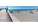 Beach with pier, showing people relaxing and enjoying the ocean at 105 Dartmouth Rd, Venice, FL 34293