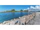 Serene waterway with rock barriers and lush greenery at 105 Dartmouth Rd, Venice, FL 34293