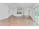 Open living room with tile floor and view of kitchen and backyard at 105 Dartmouth Rd, Venice, FL 34293