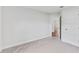 Simple bedroom with an open door to another room at 105 Dartmouth Rd, Venice, FL 34293