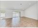Spacious living room with tile flooring and sliding glass doors at 105 Dartmouth Rd, Venice, FL 34293