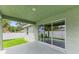 Covered patio with sliding glass doors and backyard view at 105 Dartmouth Rd, Venice, FL 34293