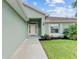 Front entry with walkway leading to a light teal home at 105 Dartmouth Rd, Venice, FL 34293