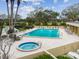 Community pool and spa with lounge chairs at 2620 Cove Cay Dr # 107, Clearwater, FL 33760