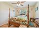 Bedroom with hardwood floors and a wooden four-poster bed at 6220 5Th S Ave, St Petersburg, FL 33707