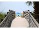 Wooden walkway to beach with ocean view at 6220 5Th S Ave, St Petersburg, FL 33707