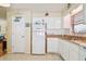White kitchen with ample cabinet space and stainless steel sink at 6220 5Th S Ave, St Petersburg, FL 33707