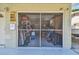 Screened garage with various storage items and shelving at 6220 5Th S Ave, St Petersburg, FL 33707