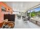 Relaxing screened porch with seating and TV at 6220 5Th S Ave, St Petersburg, FL 33707