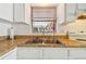 Stainless steel double sink with granite countertop and window above at 6220 5Th S Ave, St Petersburg, FL 33707