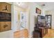 Hallway view of bathroom with TV and decorative items at 6220 5Th S Ave, St Petersburg, FL 33707