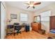 Bright bedroom featuring wood floors, a desk, and ample closet space at 6220 5Th S Ave, St Petersburg, FL 33707
