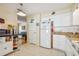 White kitchen with stainless steel appliances and ample cabinet storage at 6220 5Th S Ave, St Petersburg, FL 33707