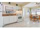 White kitchen cabinets, granite counters, and a breakfast nook create a functional space at 6220 5Th S Ave, St Petersburg, FL 33707