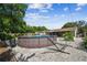 Large above ground pool surrounded by a gravel yard and hammock at 6220 5Th S Ave, St Petersburg, FL 33707