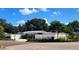 White house with a fenced yard and manicured hedges at 6220 5Th S Ave, St Petersburg, FL 33707