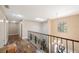 Upstairs hallway with wood floors and a skylight at 8417 Cranes Roost Dr, New Port Richey, FL 34654