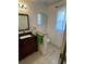 Clean bathroom with granite vanity and updated fixtures at 24327 Buckingham Way, Punta Gorda, FL 33980