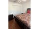 Bedroom features hardwood floors and large closet at 24327 Buckingham Way, Punta Gorda, FL 33980