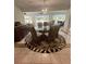 Bright dining room with glass-top table and seating for six at 24327 Buckingham Way, Punta Gorda, FL 33980