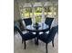 Sunlit dining room with a table and four blue chairs at 24327 Buckingham Way, Punta Gorda, FL 33980