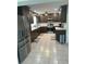 Modern kitchen with stainless steel appliances and dark cabinetry at 24327 Buckingham Way, Punta Gorda, FL 33980